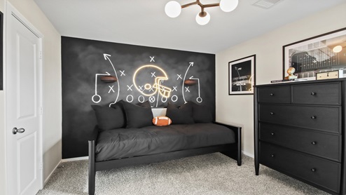 primary bedroom with large windows and carpet flooring