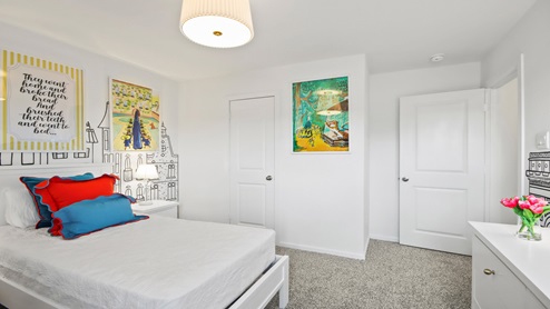 primary bedroom with large windows and carpet flooring