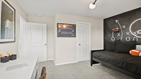 primary bedroom with large windows and carpet flooring