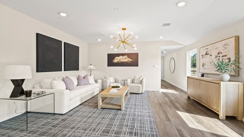 open concept living room with vinyl flooring and large windows