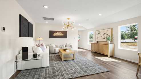 open concept living room with vinyl flooring and large windows