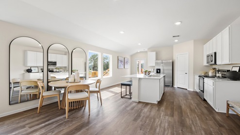 open concept living room with vinyl flooring and large windows