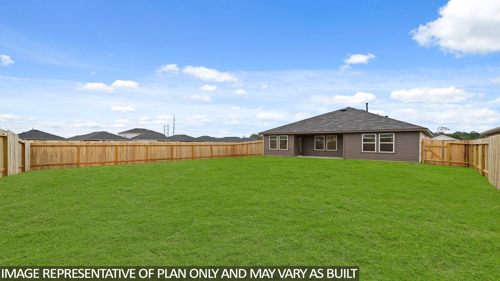 Landscaped backyard with a covered patio.