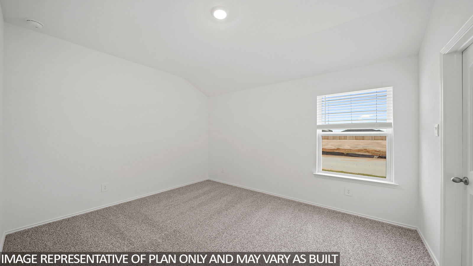 Secondary bedroom with windows, white walls, and light carpet.
