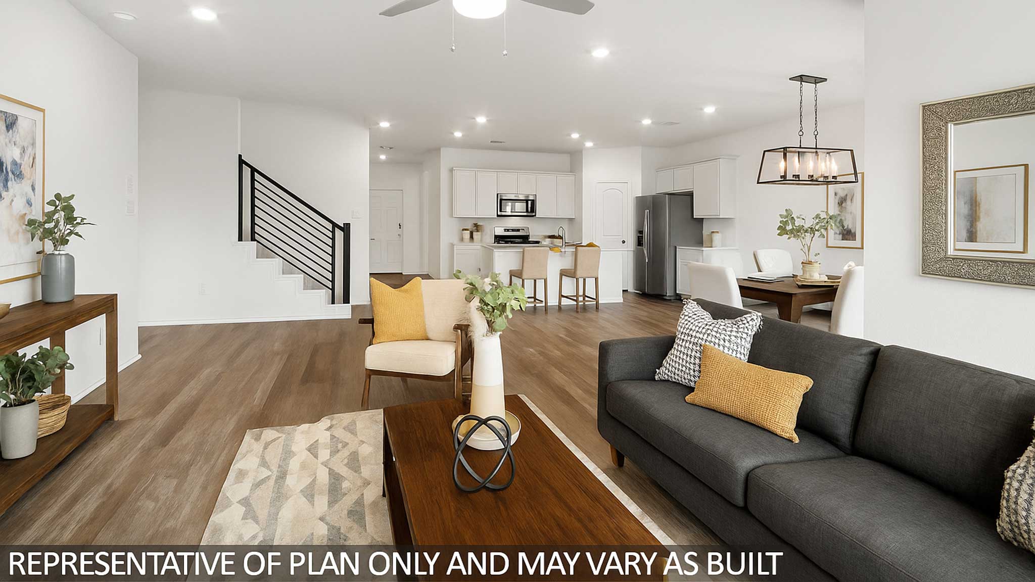 Open living room with windows, white walls, and vinyl wood flooring.