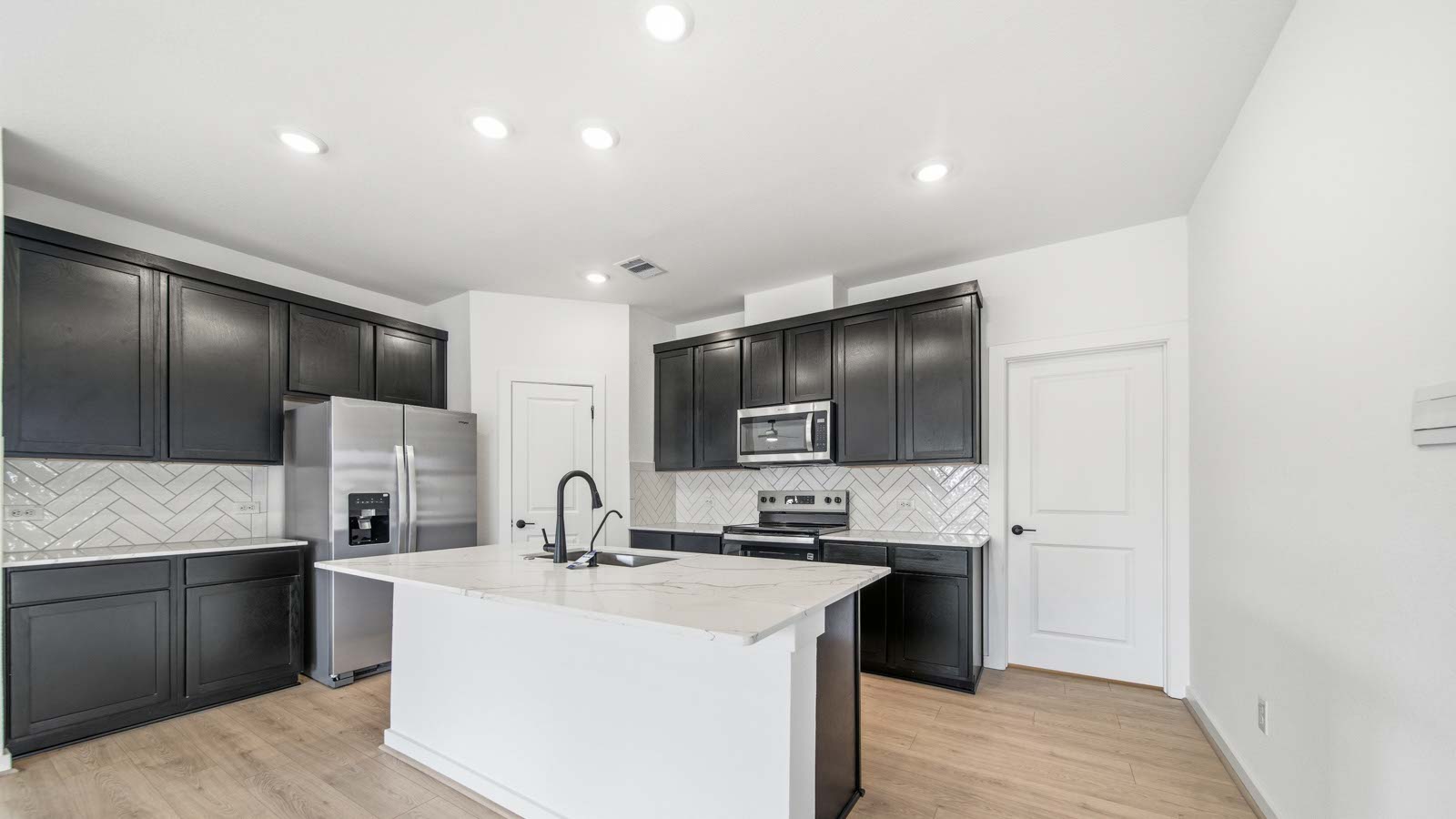 Kitchen with an island and vinyl floor