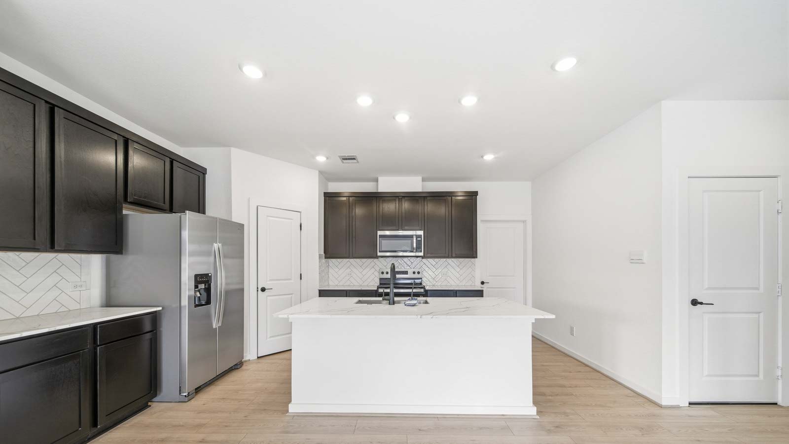 Kitchen with an island and vinyl floor