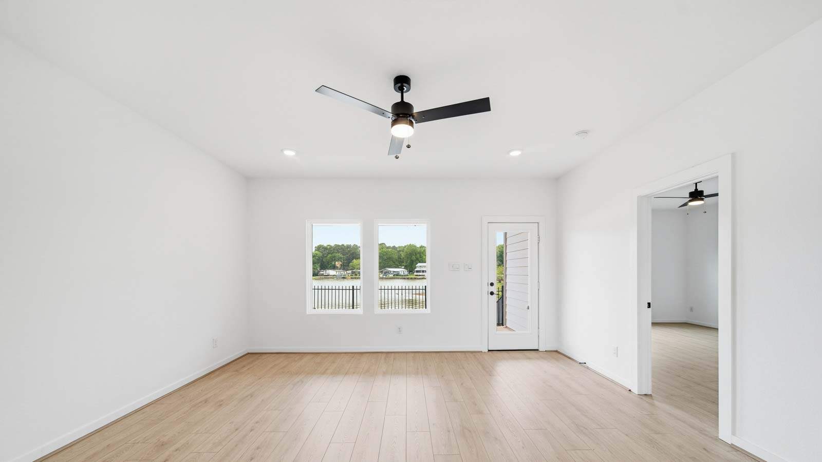 Spacious living area with vinyl flooring