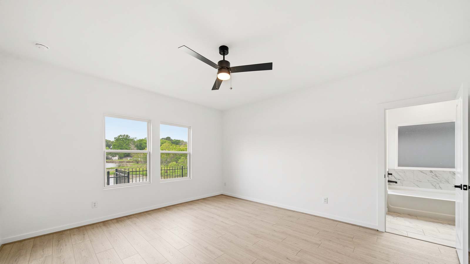 Primary bedroom with vinyl  flooring