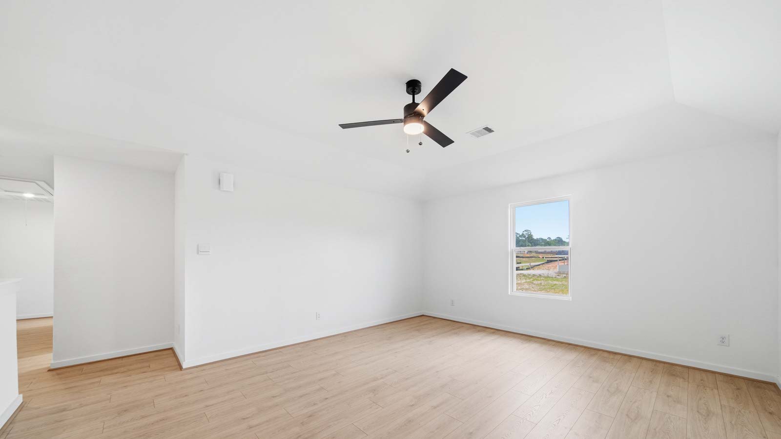 Spacious living area with vinyl flooring