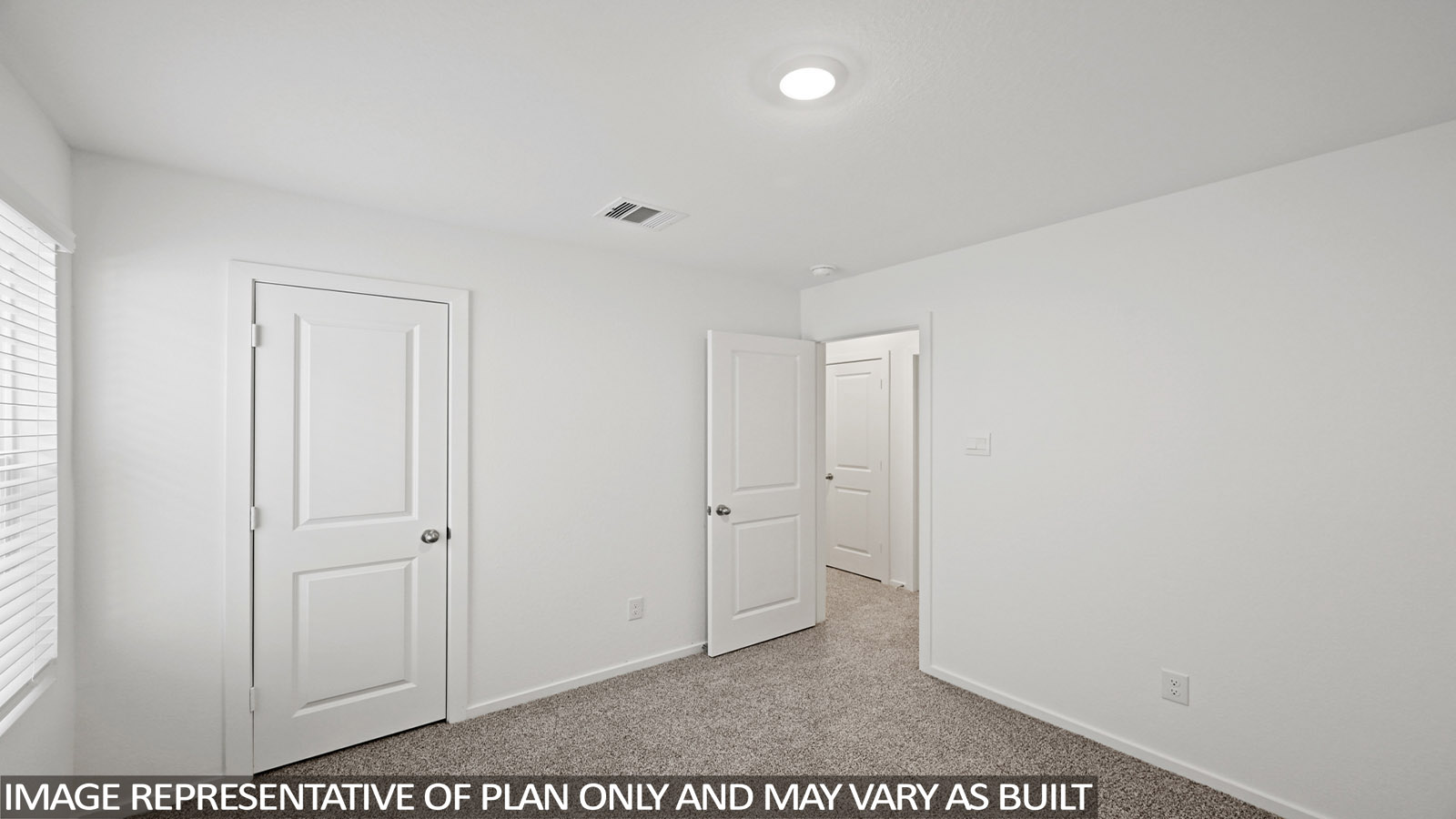Secondary bedroom with carpet flooring