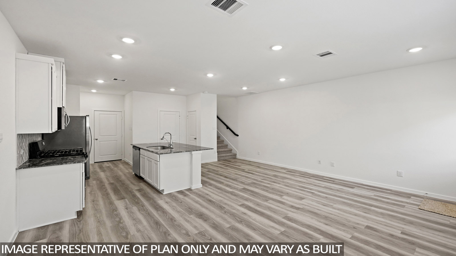 Spacious living area with vinyl flooring
