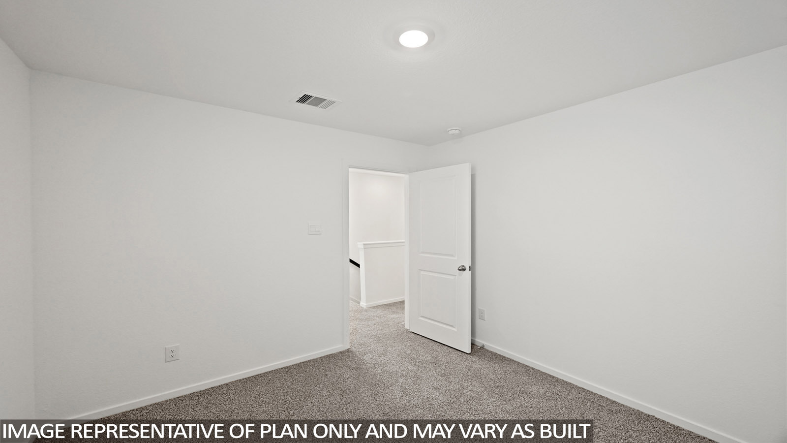 Secondary bedroom with carpet flooring