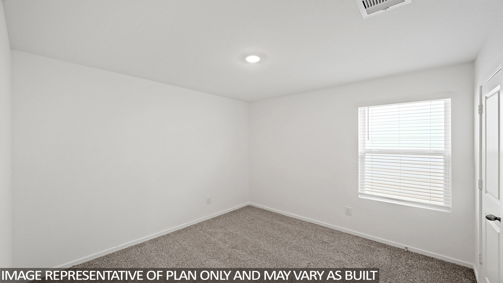 Secondary bedroom with carpet flooring