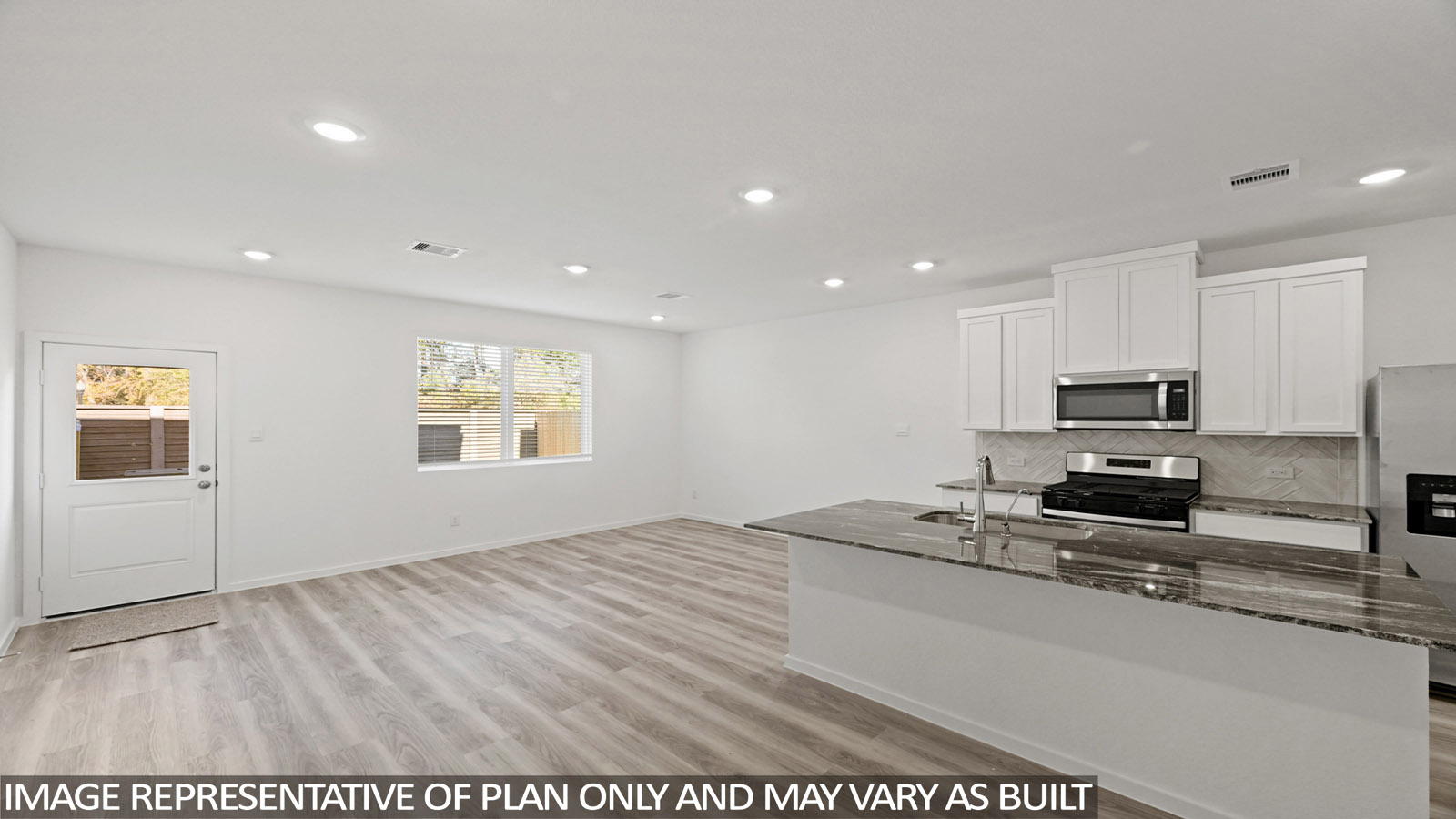 Spacious living area with vinyl flooring