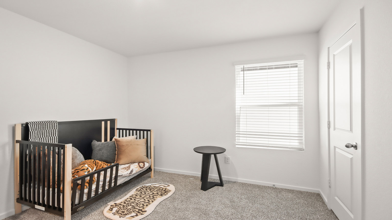 Secondary bedroom with carpet flooring