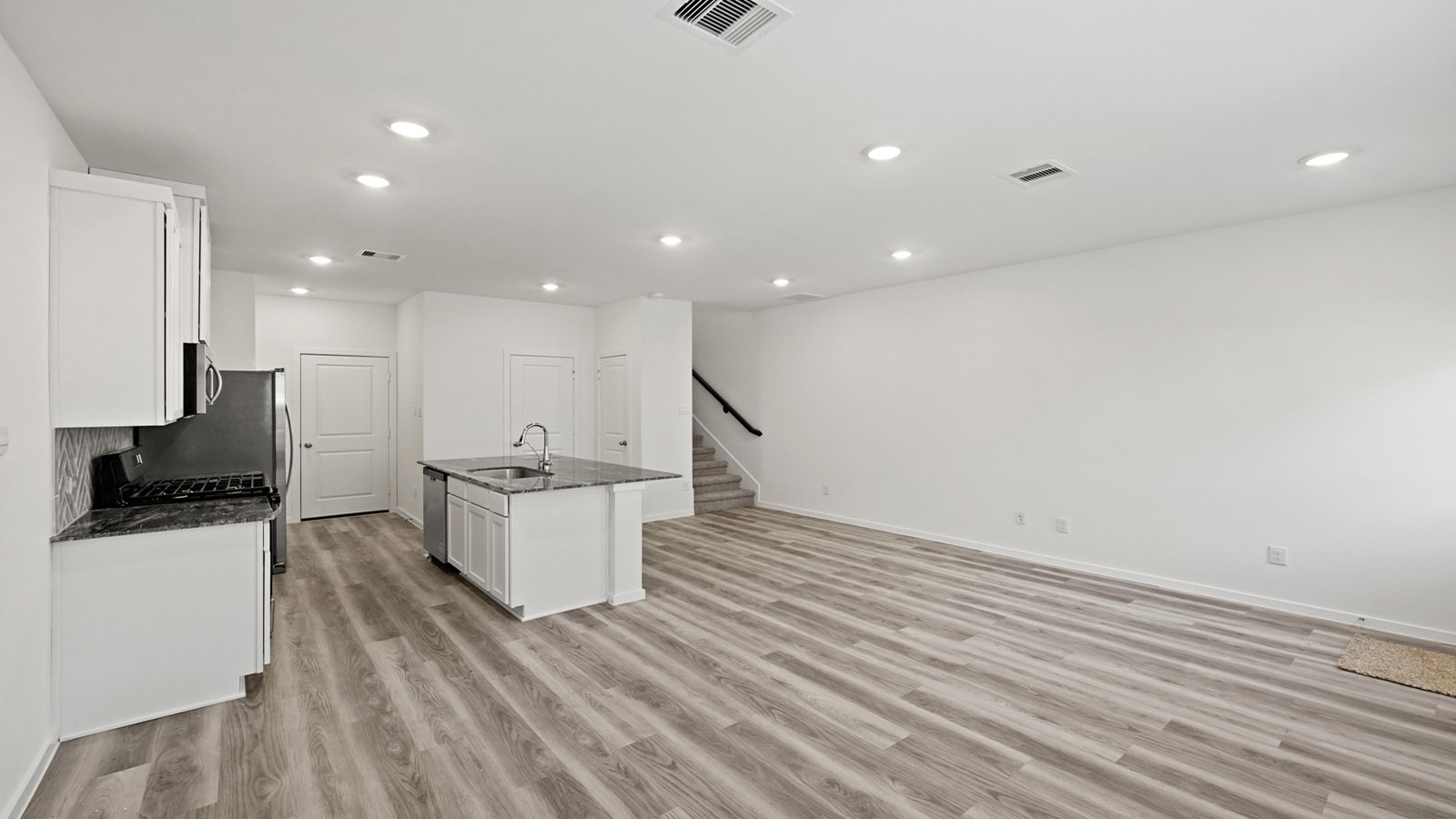 open concept living, dining, and kitchen