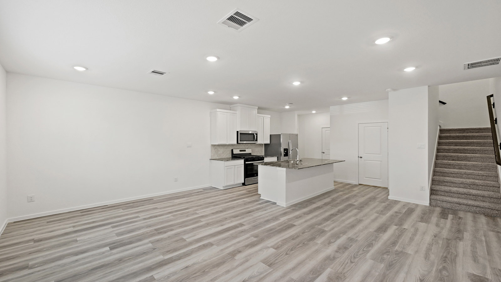 open concept living, dining, and kitchen