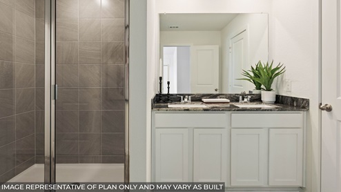primary bathroom with double sink and shower