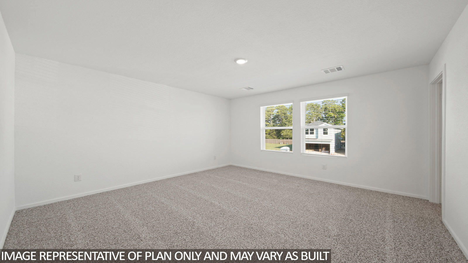 Primary bedroom with carpet flooring