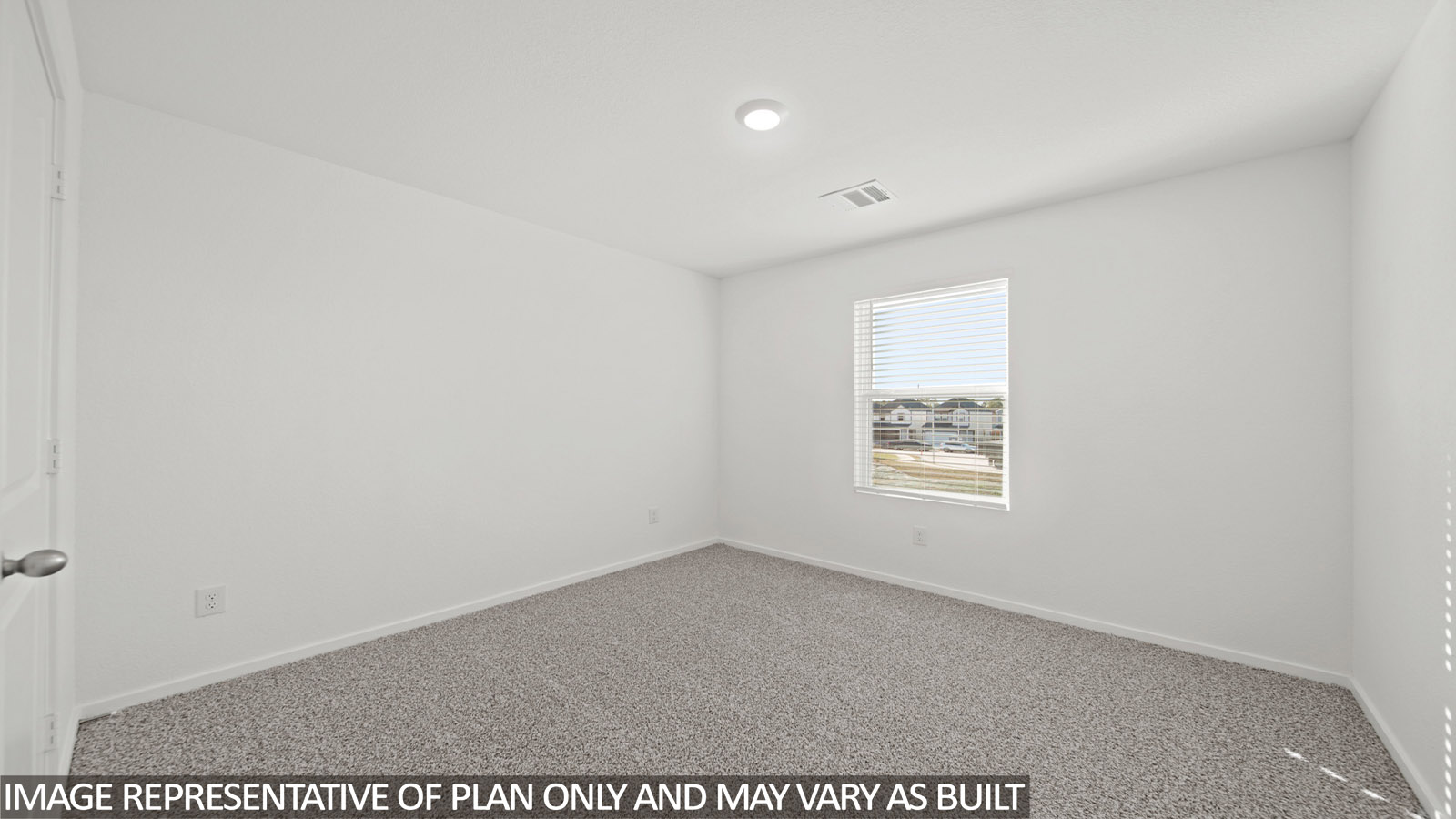 Secondary bedroom with carpet flooring