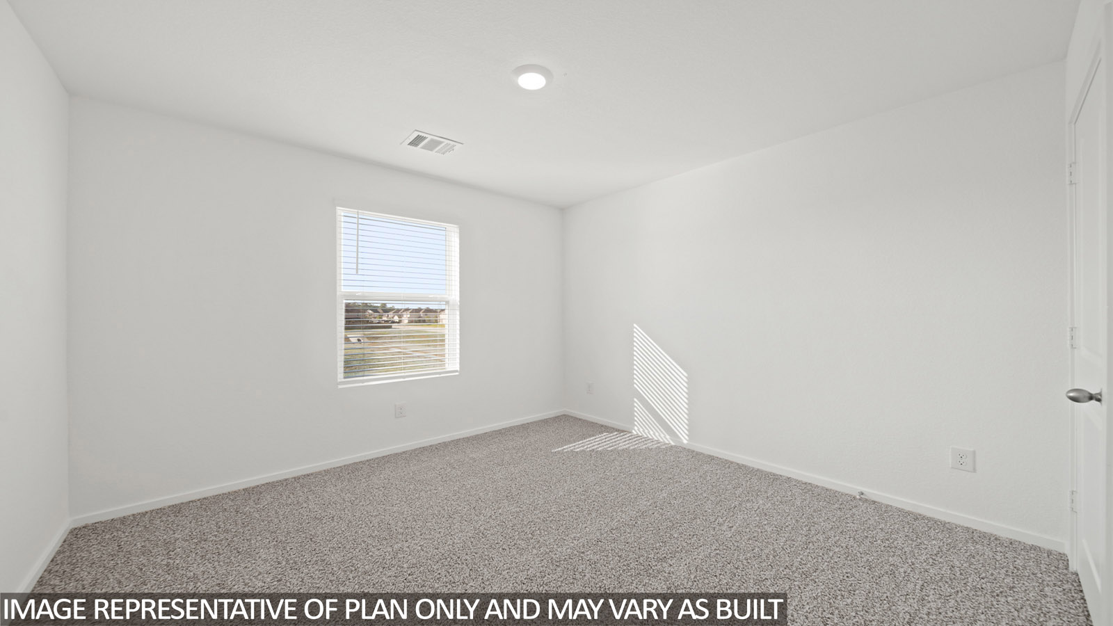 Secondary bedroom with carpet flooring