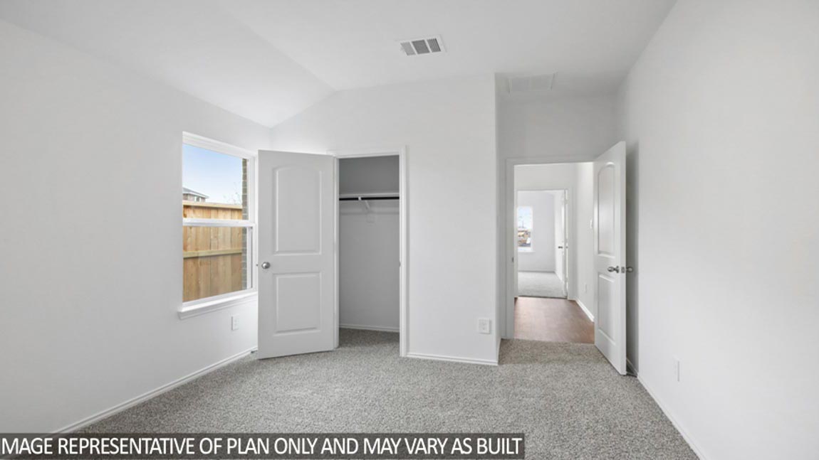 Secondary bedroom with carpet flooring