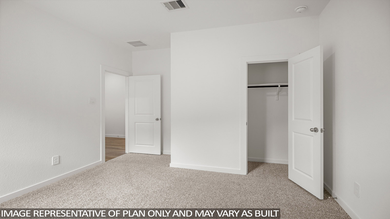 Secondary bedroom with carpet flooring