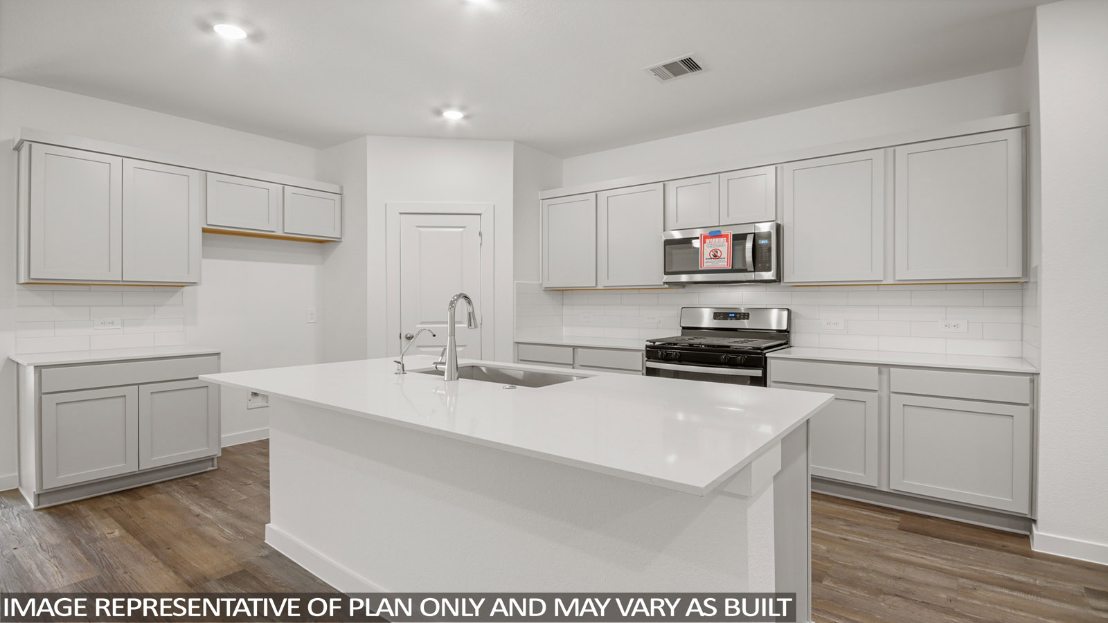 Kitchen with an island and vinyl floor