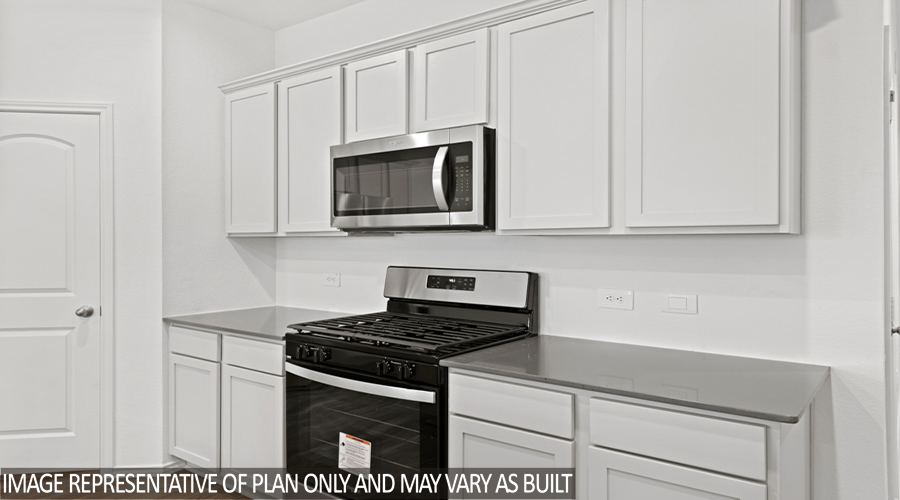Kitchen with island and stainless-steel appliances.