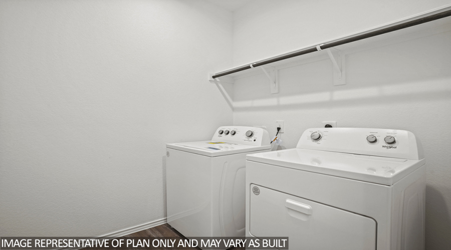 Utility room with overhead storage space.