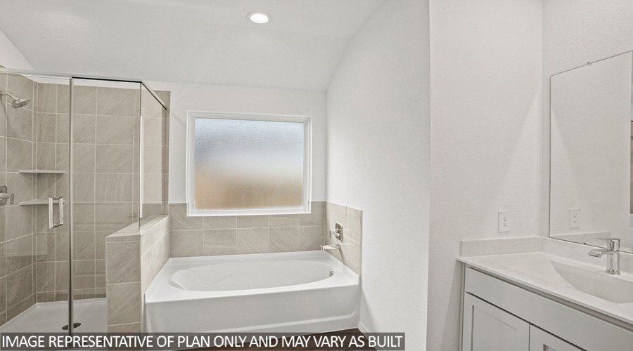 Primary bathroom with standing shower and tile tub.