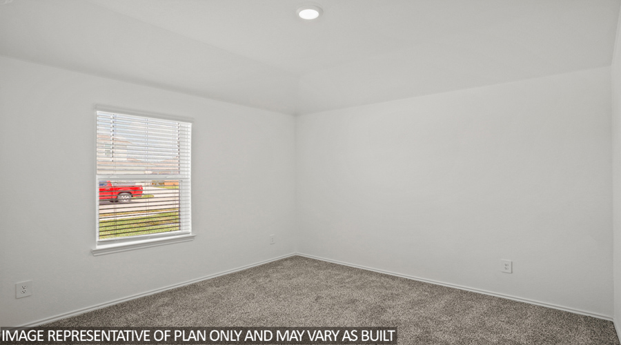 Secondary bedroom with carpet flooring and a bright window.