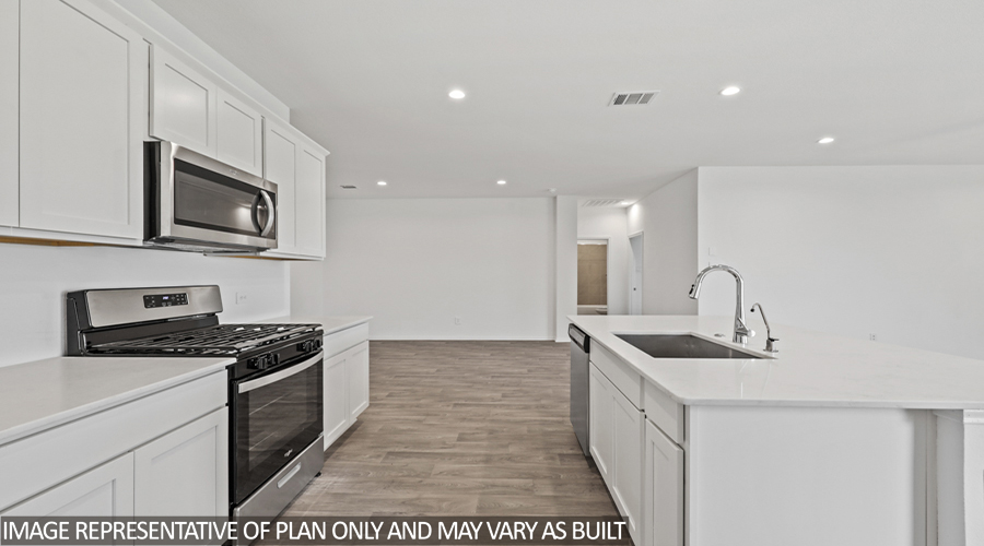 Kitchen with island and stainless-steel appliances.