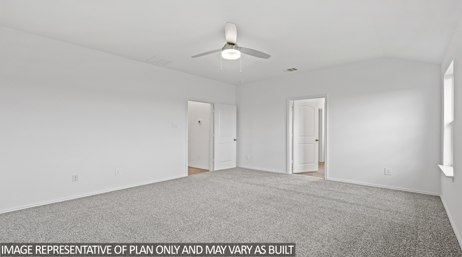 Primary bedroom with carpet flooring.