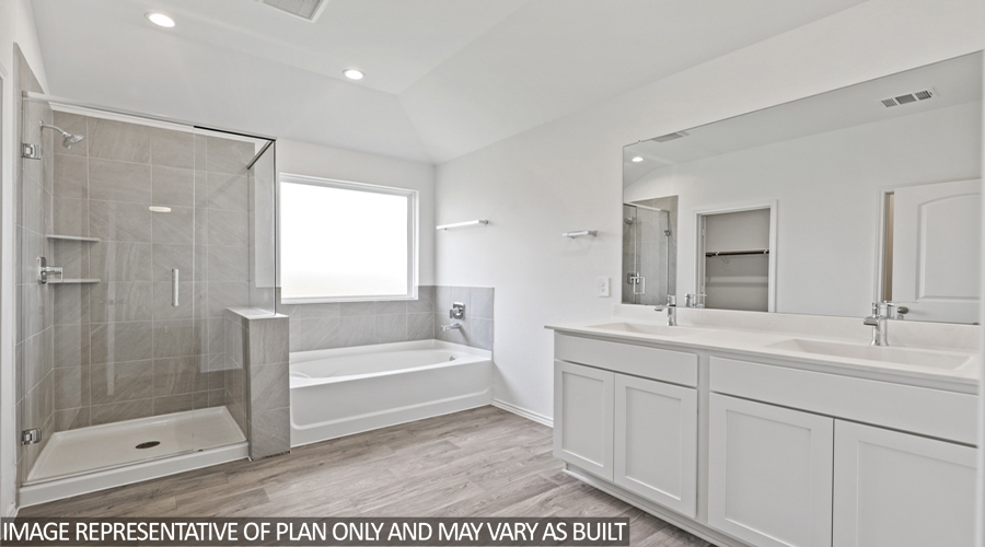 Primary bathroom with tub and standing shower.