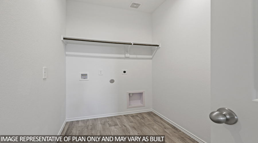 Utility room with overhead storage space.