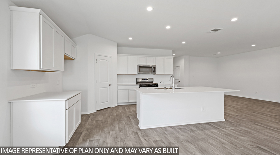 Kitchen with island and stainless-steel appliances.