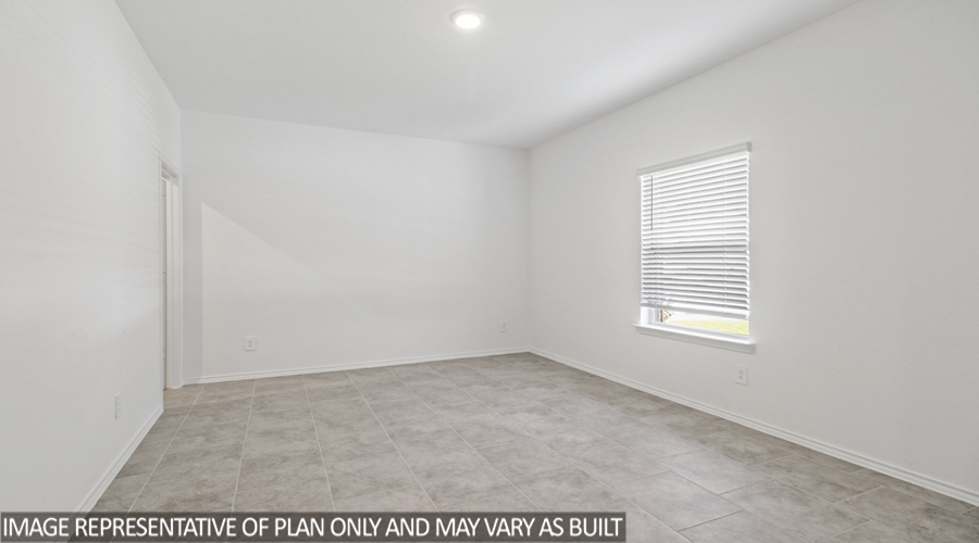 Secondary bedroom with carpet flooring and a bright window.