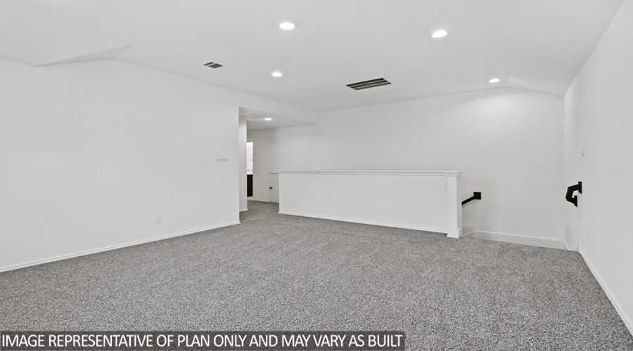 Upstairs game room with carpet flooring.