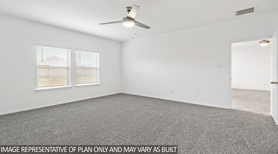 Primary bedroom with carpet flooring and a bright window.