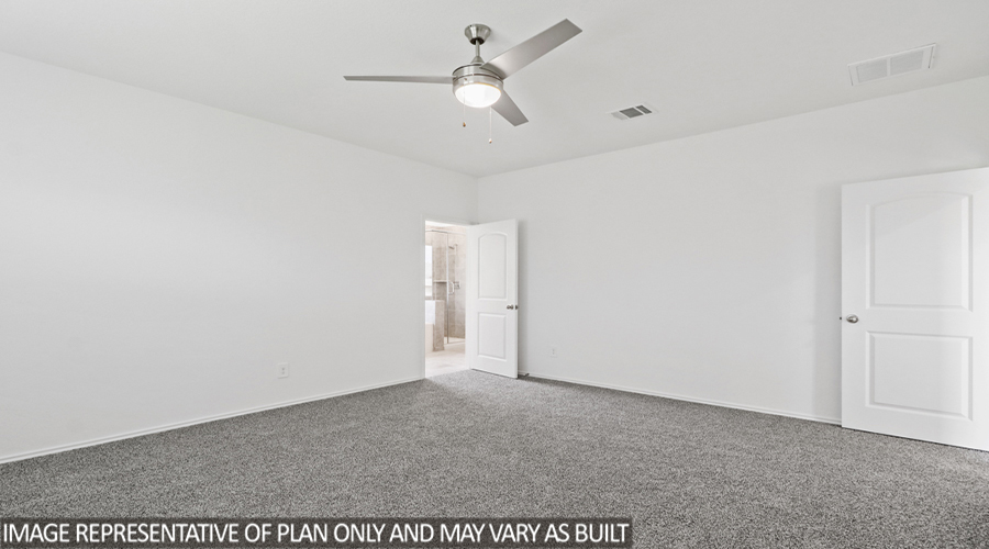 Primary bedroom with carpet flooring.