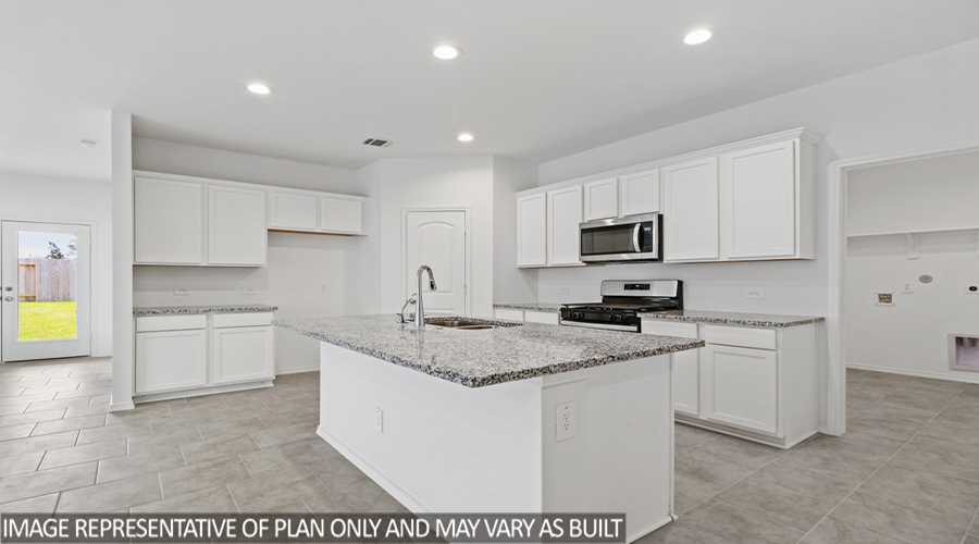 Kitchen with island and stainless-steel appliances.