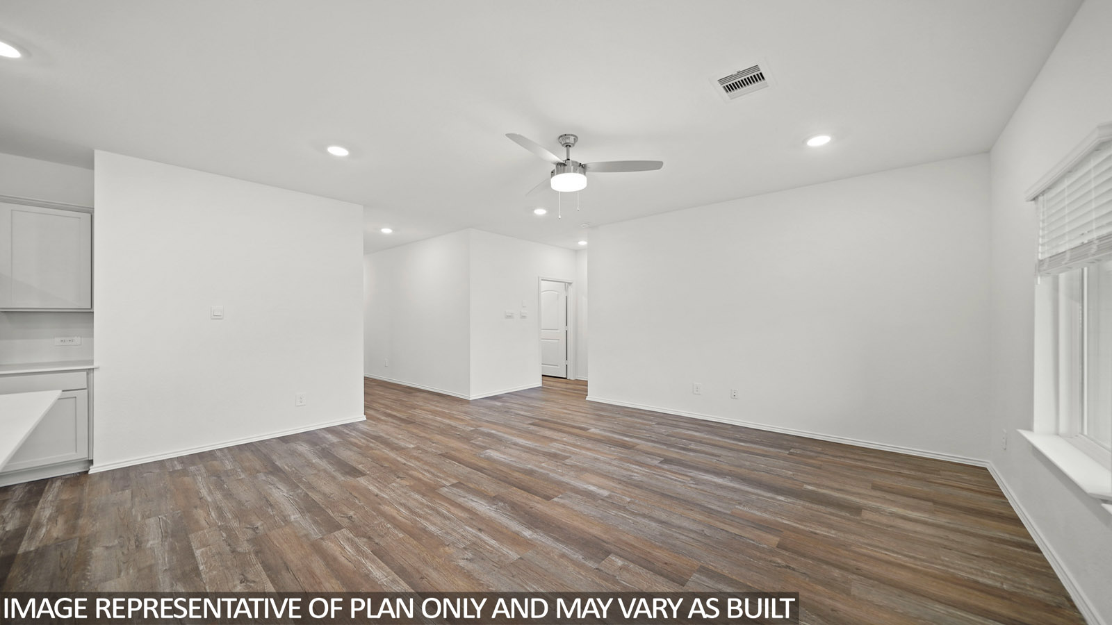 Spacious living area with vinyl flooring