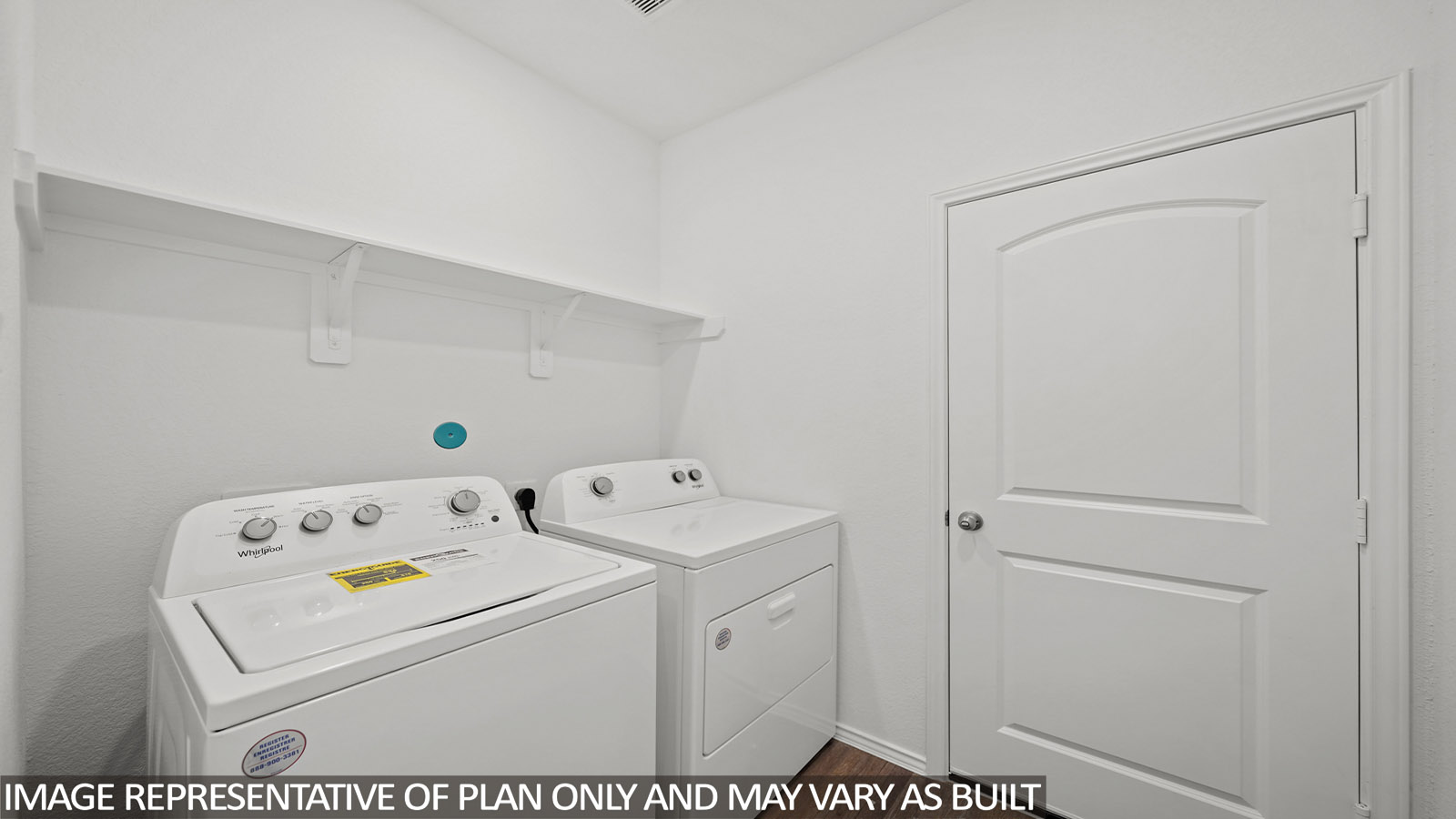 Utility room with vinyl flooring and overhead storage space.