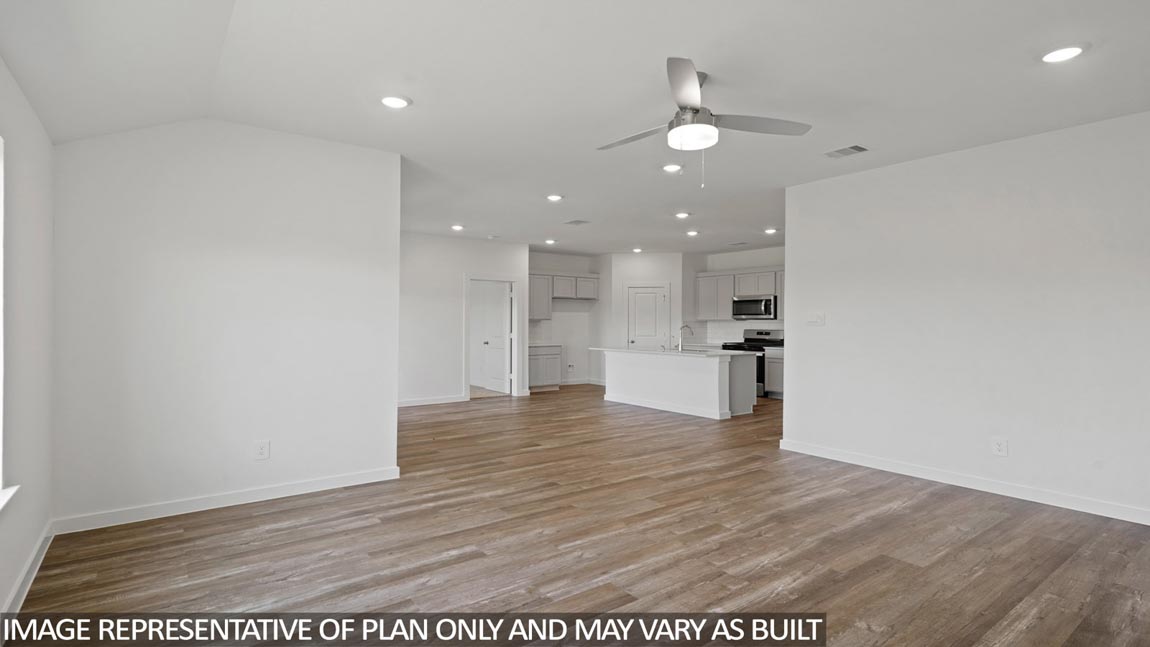 Spacious living area with vinyl flooring