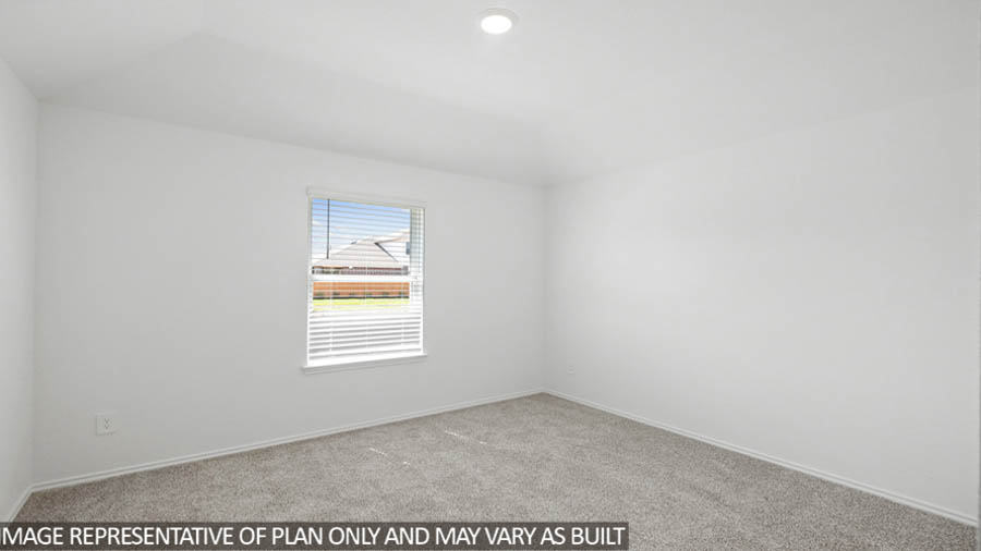 Secondary bedroom with carpet flooring