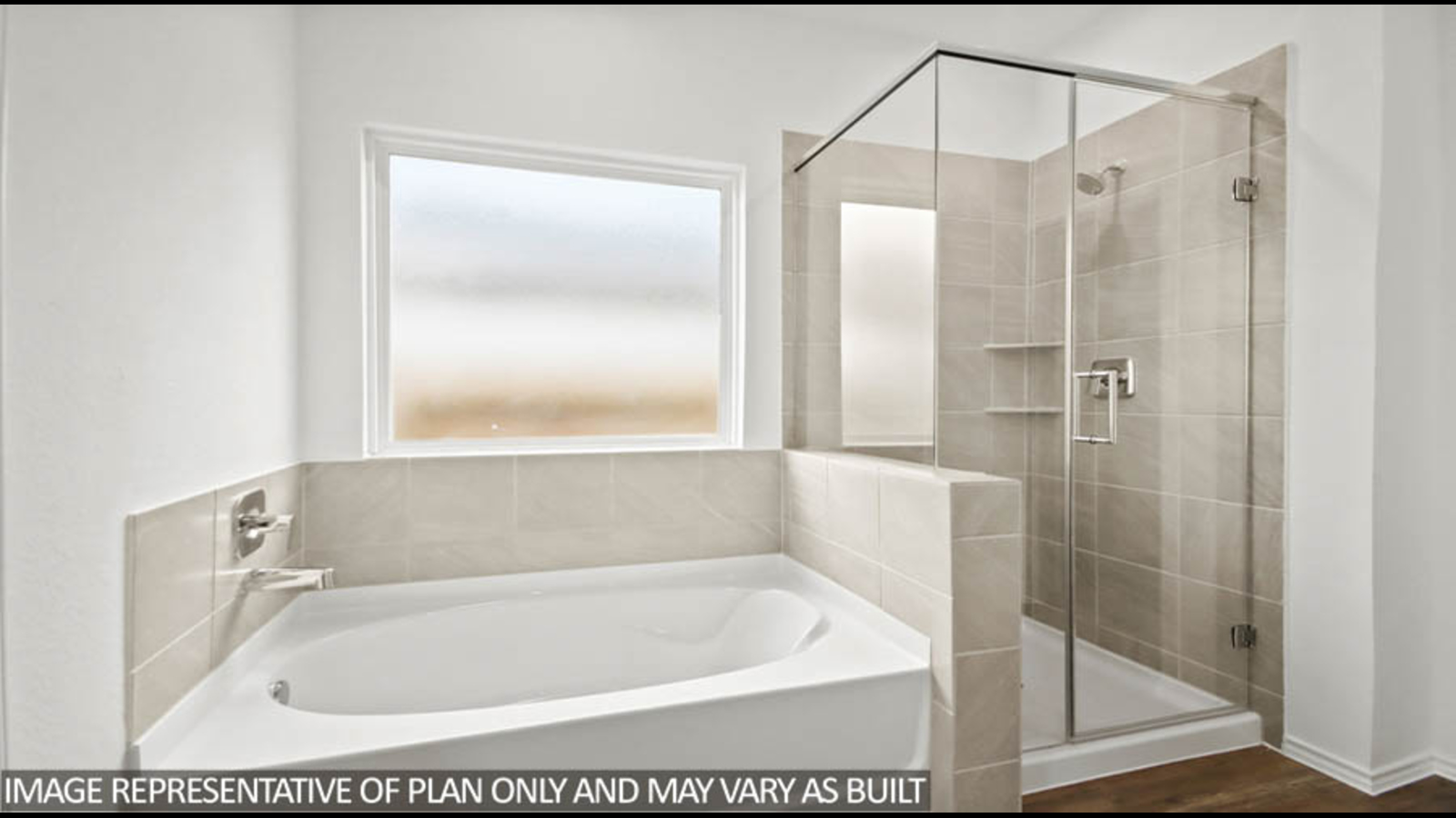 Primary bathroom with a tile tub, a standing shower with a glass door, and a frosted window.