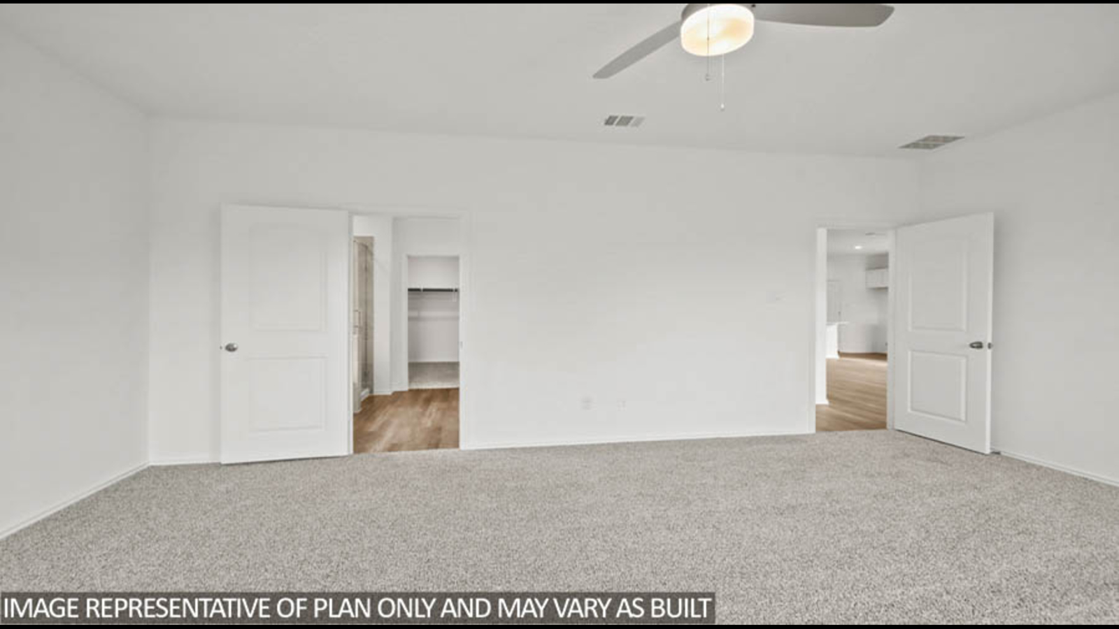 Primary bedroom with carpet flooring and a ceiling fan.