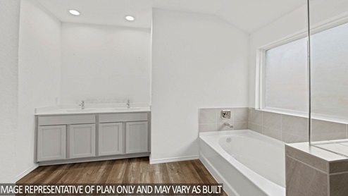 Primary bathroom with tub and standing shower